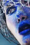 close-up portrait of woman with blue powder